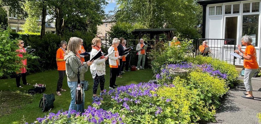 Image of Kaleidoscope Community Choir singing in garden